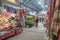 Interior inside of market hall showing a variety of stalls vendors and customers browsing