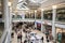 Interior inside of modern shopping centre mall with luxury chandelier and people