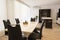 Interior of kitchen and dining room, white kitchen cabinetry and steel appliances. Interior photography. Open space living room