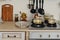 Interior kitchen gas stove with iron pots and pans, dining equipment