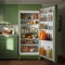 Interior of a Kitchen with an Integrated Refrigerator and 1960s Style Olive Green Kitchen Units