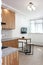 Interior of the kitchen in Scandinavian motifs, oak furniture with a clay bowl with plums and a window, homeliness