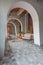 Interior of a large apartment in oriental mixed with loft style with arches, led lighting and bright orange elements