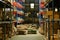 Interior of large logistic distribution warehouse full of shelves with goods in cardboard boxes and pallets