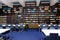 The interior of the library. Blue and brown colors. Bookcases with books, white tables