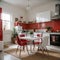 Interior of light kitchen with red fridge white counters and dining table