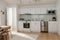 Interior of light kitchen with washing machine, oven and white counters