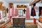 The interior of the living quarters of an antique Ukrainian rural hut with holy images above the window and old clothes and dishes