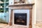 Interior of living room with fireplace and fitted display and storage cabinet