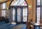 Interior lobby area of The Royal Hotel in Whitby showing art deco architecture, revolving entrance door, windows and seating