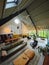 Interior of a loft. Living room with midcentury modern furniture. Concrete floor and plants. Mustard yellow chair