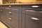 Interior of luxurious wooden modern kitchen grey cabinets