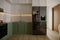 Interior of Minimalist Open Kitchen With White and Green Ava and Black Fridge