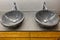 Interior of a modern bathroom with two stone sinks standing on brown furniture