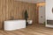 Interior of modern bathroom with white and wooden walls, floor and plants, comfortable white bathtub with faucet,