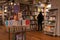 Interior of a modern bookshop with woman browsing the collection.