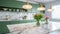 Interior of modern classic kitchen. Marble countertop, marble backsplash and green cabinets, flowers in glass jars