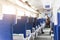 Interior of modern intercity express train. Back view of wide comfortable seats in row at railroad transport. Sunrise