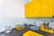Interior of the modern kitchen in loft flat apartment in minimalistic style with yellow color