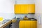 Interior of the modern kitchen in loft flat apartment in minimalistic style with yellow color