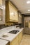 Interior of modern kitchen with plates on counter by stove