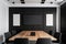 Interior of modern office meeting room black and white with wooden furniture conference table with black chairs and mock up Made