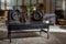 interior of modern retro styled living room with two clocks and dried flowers on wooden