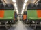 Interior of a modern train, perspective of an empty carriage with bright multi-colored seats