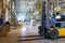 Interior of a modern warehouse with forklifts. Pallet stacker truck equipment at warehouse. Forklift loader