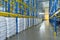 Interior of a modern warehouse storage of retail shop with pallet truck near shelves. Rows of steel shelves and racks