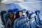 Interior of a nearly empty airplane. Photo of a family sitting near the back of the plane on a not full flight.