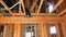 Interior of a new home wooden beams at construction residential house framing