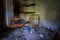 Interior of an old abandoned bedroom with damaged furniture