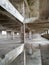 Interior of an old abandoned concrete hall. Empty messy industrial warehouse with several floors and a hole in the floor