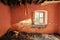 Interior of an old abandoned ruin house with white cracked walls and broken window frames