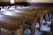 Interior of old church with carved wooden pews and stained glass windows