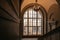 Interior with an old historical staircase and a huge stained glass window, the floors of the Museum