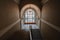 Interior with an old historical staircase and a huge stained glass window, the floors of the Museum