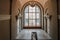 Interior with an old historical staircase and a huge stained glass window, the floors of the Museum