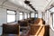 Interior of an old passenger car on a railroad. Historic vintage train Slightly left angle. Rows of seats and old style furnishing