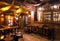 Interior of old schooner style bar with old wooden furniture, pirate themes decor, pub counter and barrels