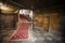 Interior of an old Spanish house with red carpet, stairs and doors