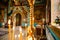 Interior of an Orthodox Ukrainian church. Burning candles on a gilded candlestick or candelabra. Temple entrance