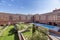 Interior patio facades of buildings in a common area with trees,