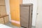 An interior photo of a bedroom with stand alone and flushed wall wooden wardrobe cardboard cabinets