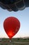 The interior of a red hot air balloon glows near Goreme in the Cappadocia region of Turkey as the propane burners are fired