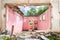 Interior remains of hurricane or earthquake disaster damage on ruined old house in the city with collapsed walls, roof and bricks