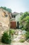 Interior remains of hurricane or earthquake disaster damage on ruined old house in the city with collapsed walls, roof tiles and b