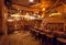 Interior of retro style bar with old wooden furniture, pirate themes decor, pub counter and barrels