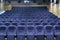 Interior room with lots of blue theater chairs